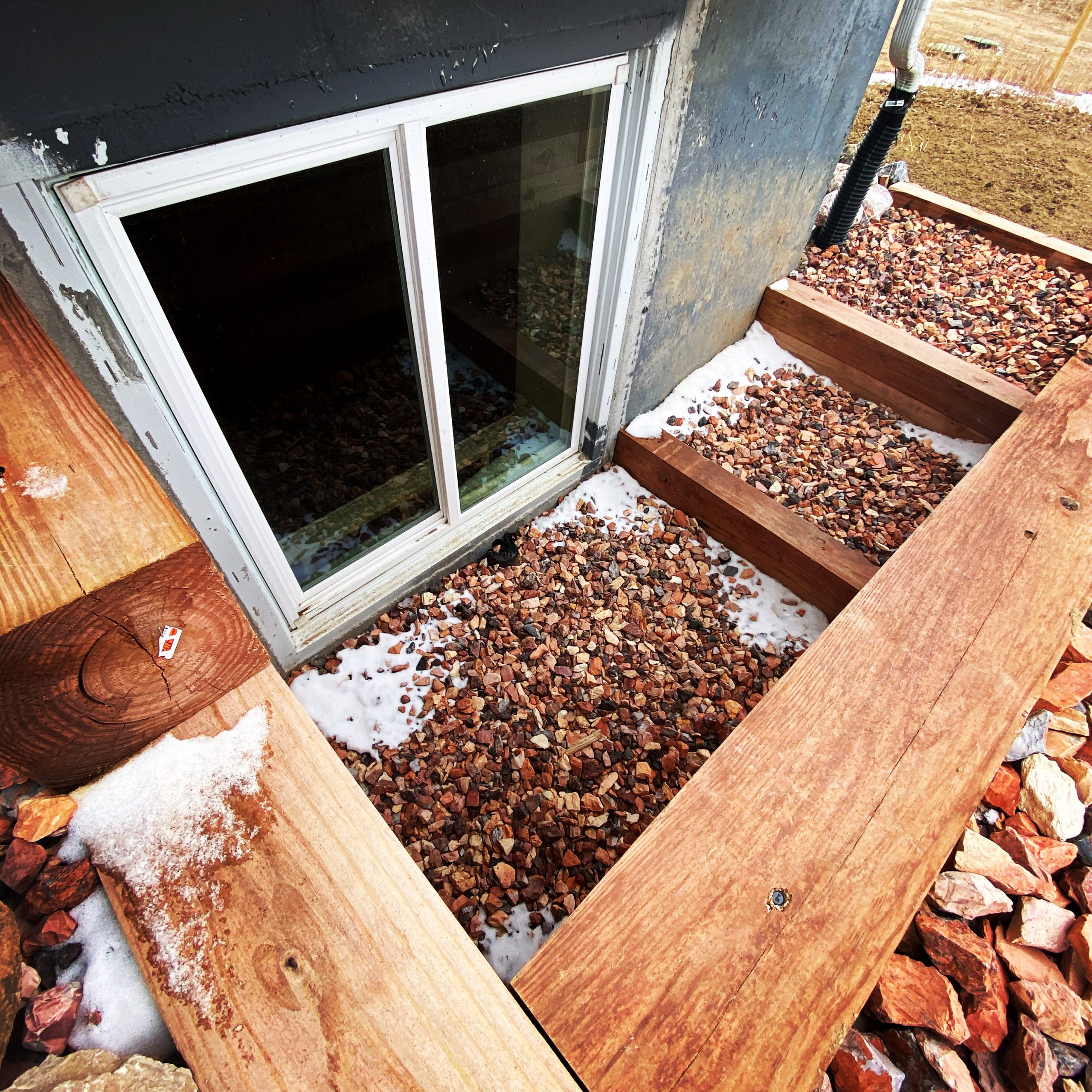Window Well Replacements in progress as installers secure a new corrugated well